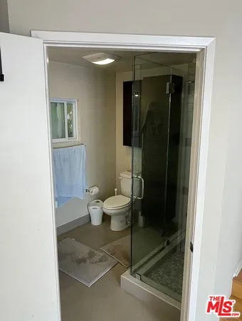 a bathroom with a toilet and a shower
