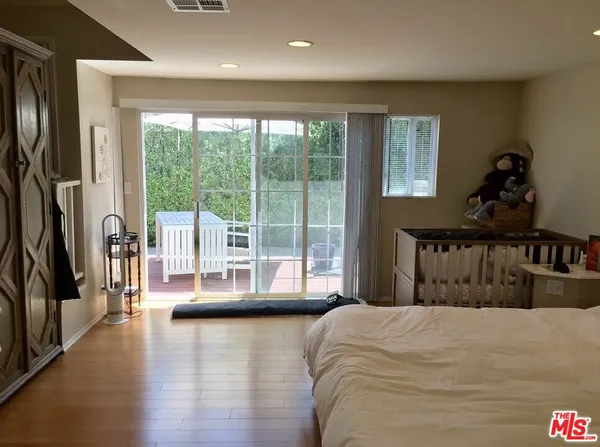 a bedroom with a large bed and a large window