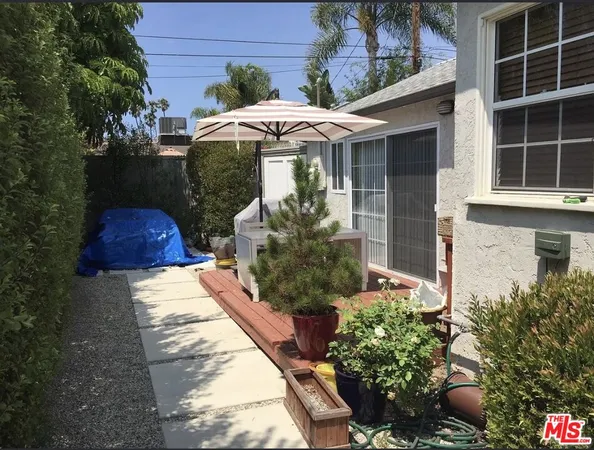 a view of a house with a yard and sitting area