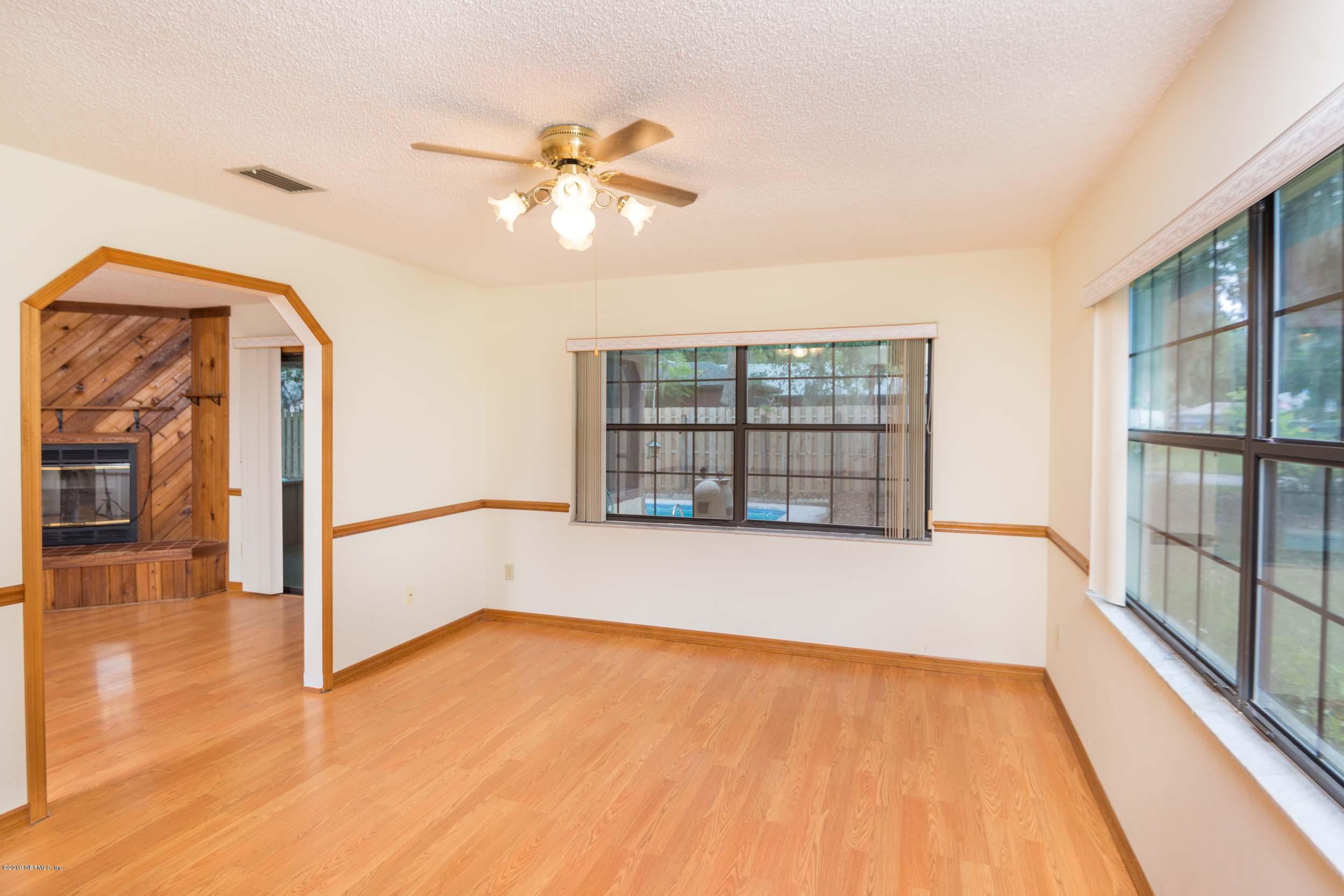 702 Miranda Road St. Augustine, FL 32086 - Photo 15 of 37 a view of an empty room with a window and wooden floor