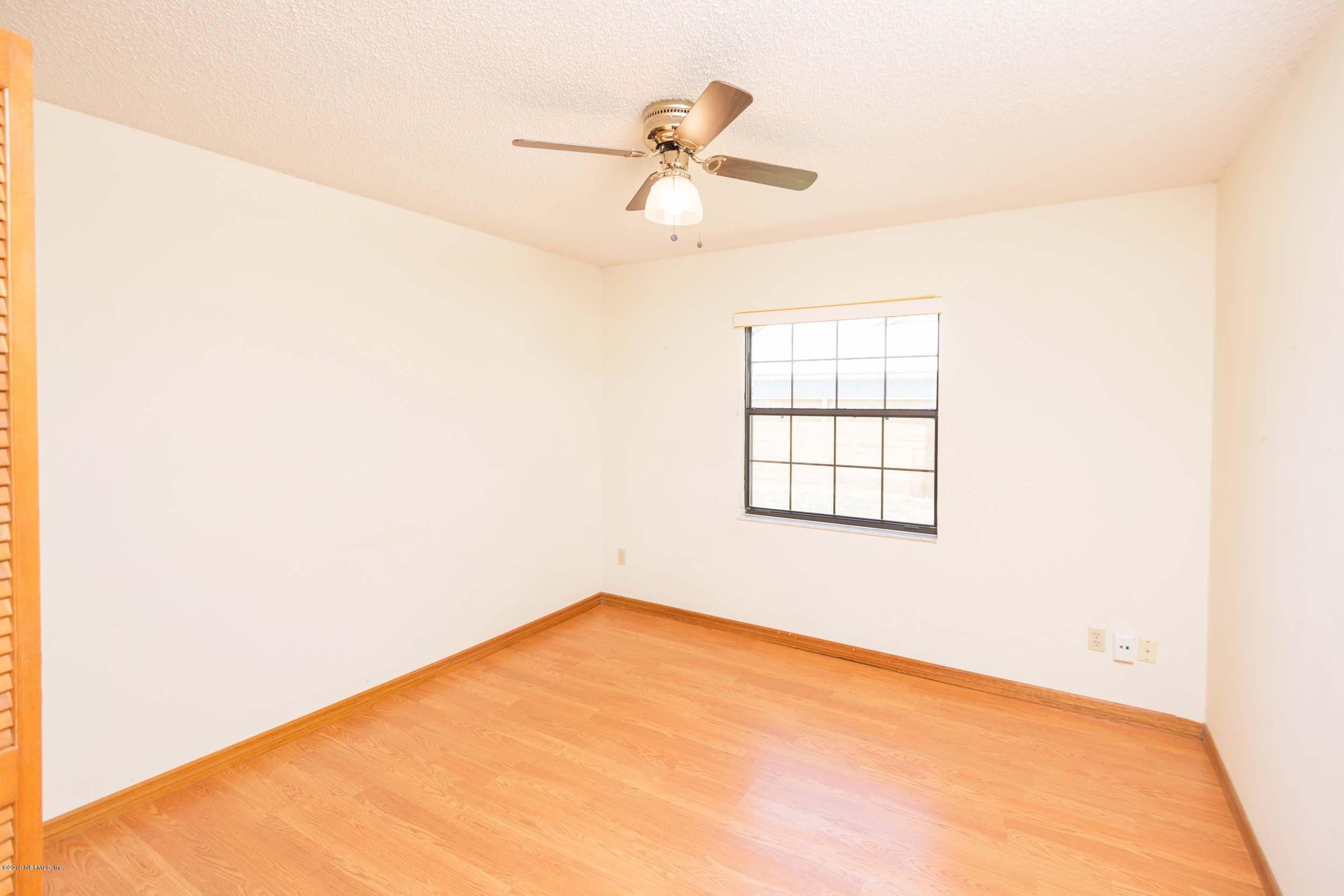 702 Miranda Road St. Augustine, FL 32086 - Photo 28 of 37 a view of a big room with windows and ceiling fan