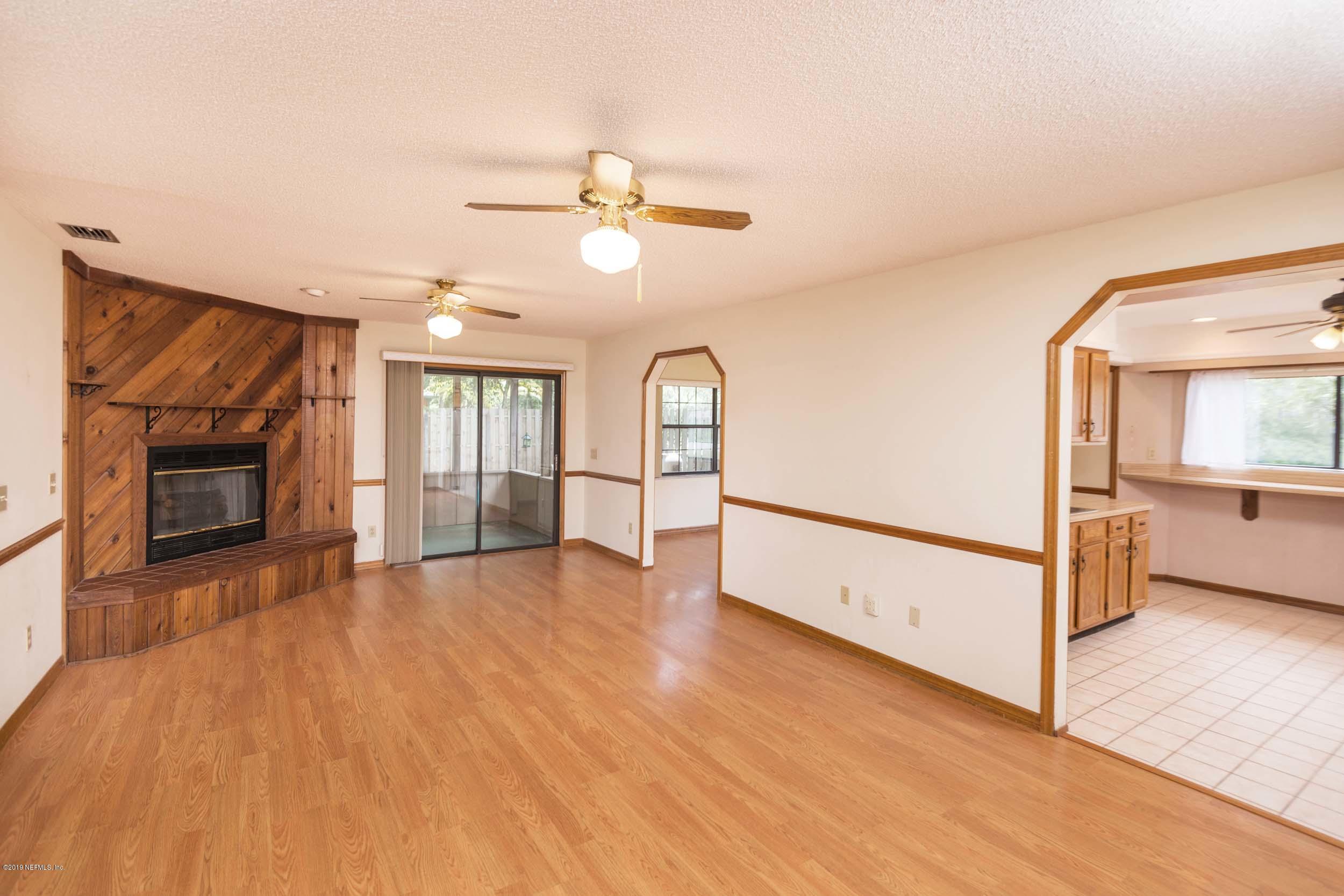 702 Miranda Road St. Augustine, FL 32086 - Photo 10 of 37 a view of empty room with wooden floor and fireplace