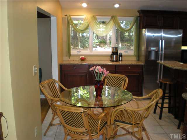 3417 Hackney Court Raleigh, NC 27613 - Photo 3 of 23 Eat-in kitchen area. Notice more cabinets and counter space in background. No lack for storage here!