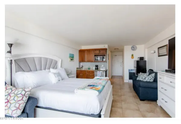a view of a tables and chairs under an umbrella in patio