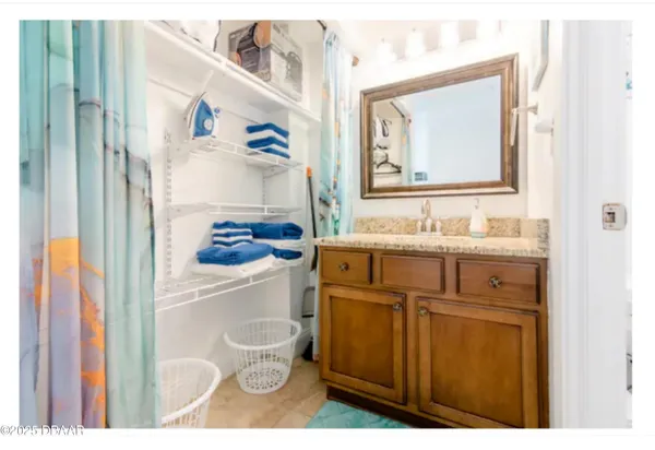 a bathroom with a granite countertop sink mirror toilet and bathtub
