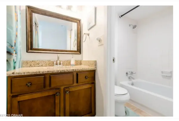 a kitchen with granite countertop a sink a stove and cabinets