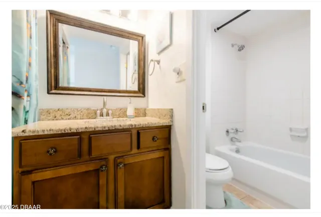 a kitchen with granite countertop a sink a stove and cabinets