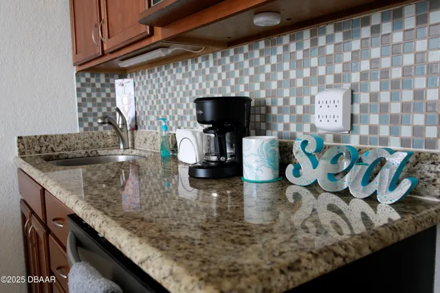 a kitchen with stainless steel appliances granite countertop a refrigerator and a wooden cabinets