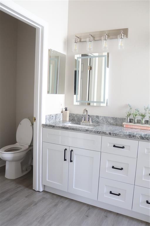 3850 Beacon Ridge Way Clermont, FL 34711 - Photo 27 of 41 a bathroom with a granite countertop sink and a mirror