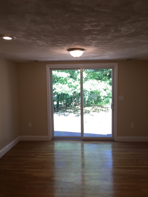 31 Pine Street Dedham, MA 02026 - Photo 4 of 11 a view of an empty room with wooden floor and a window