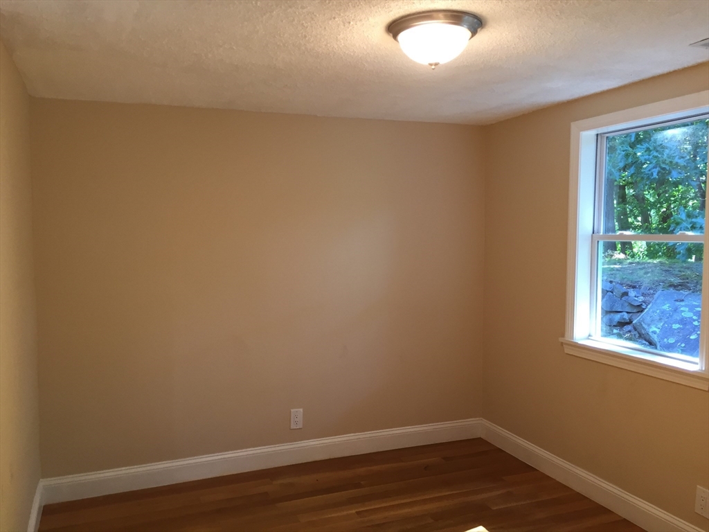 31 Pine Street Dedham, MA 02026 - Photo 7 of 11 a view of a small space with wooden floor and a window