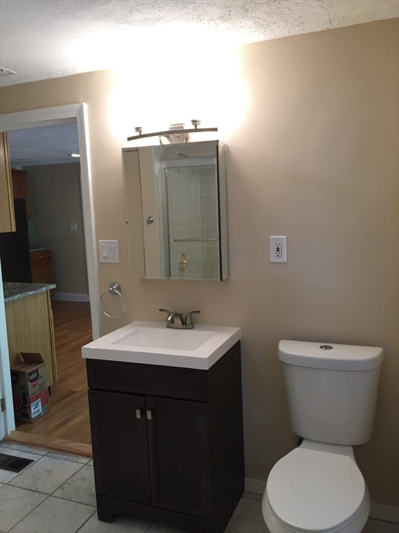 31 Pine Street Dedham, MA 02026 - Photo 9 of 11 a bathroom with a toilet sink and mirror