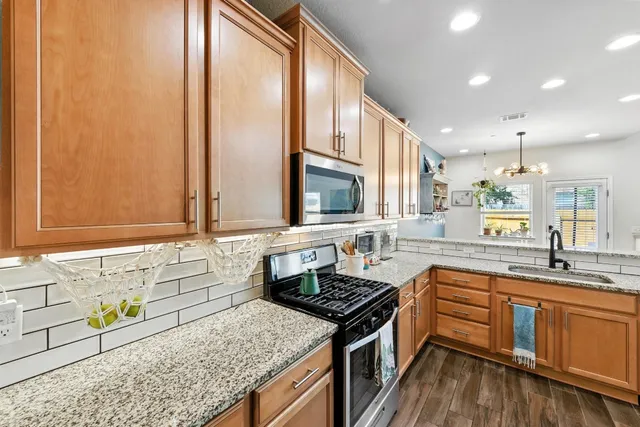 a kitchen with a sink stove and cabinets