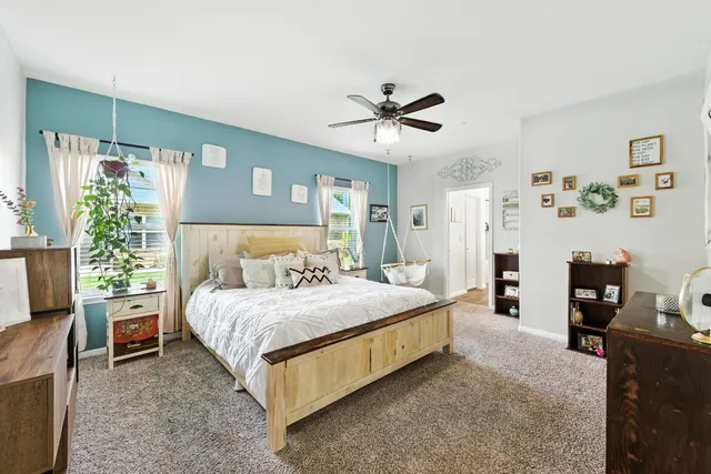 a bedroom with a bed and a large window