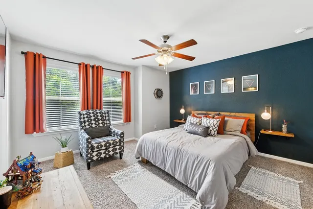a bedroom with furniture and a flat screen tv