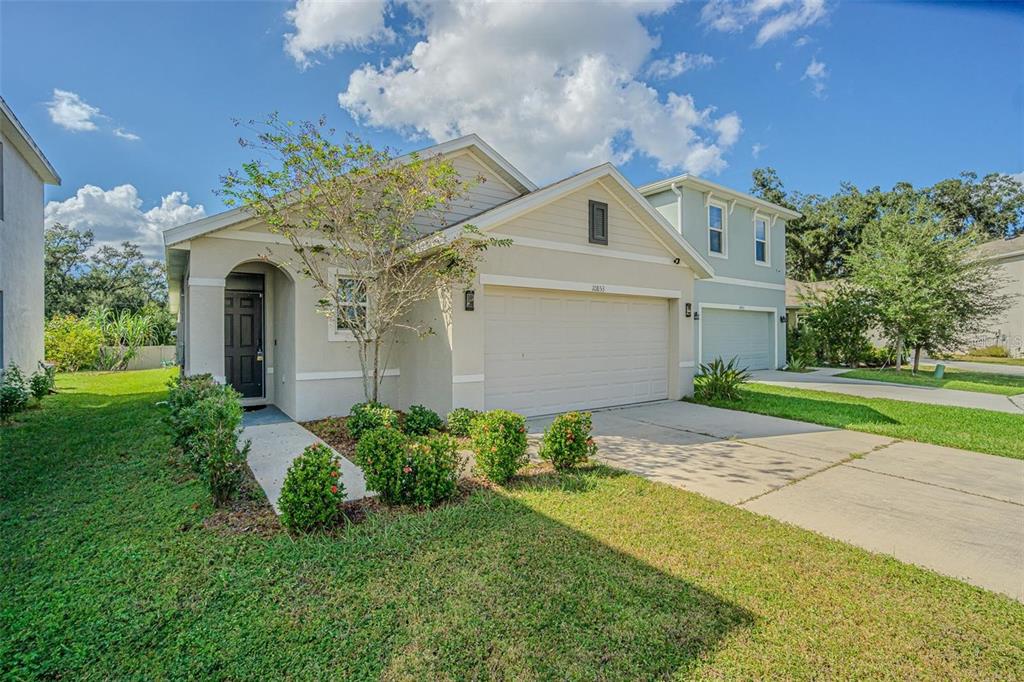 10853 Trailing Vine Drive Tampa, FL 33610 - Photo 1 of 15 a front view of a house with garden