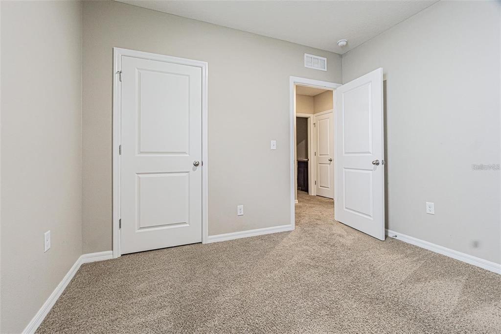 10853 Trailing Vine Drive Tampa, FL 33610 - Photo 11 of 15 an empty room with windows and closet