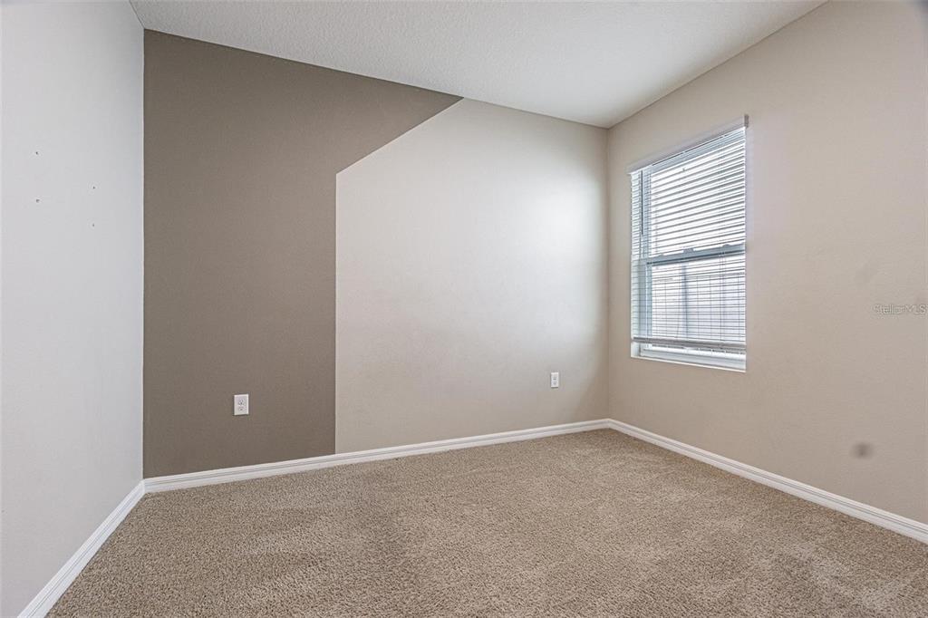 10853 Trailing Vine Drive Tampa, FL 33610 - Photo 14 of 15 an empty room with windows and closet