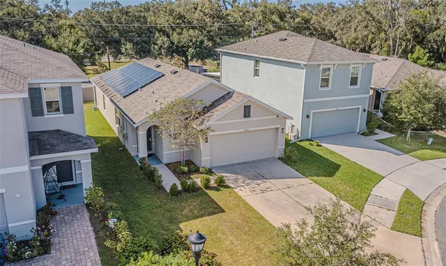 a aerial view of a house next to a yard