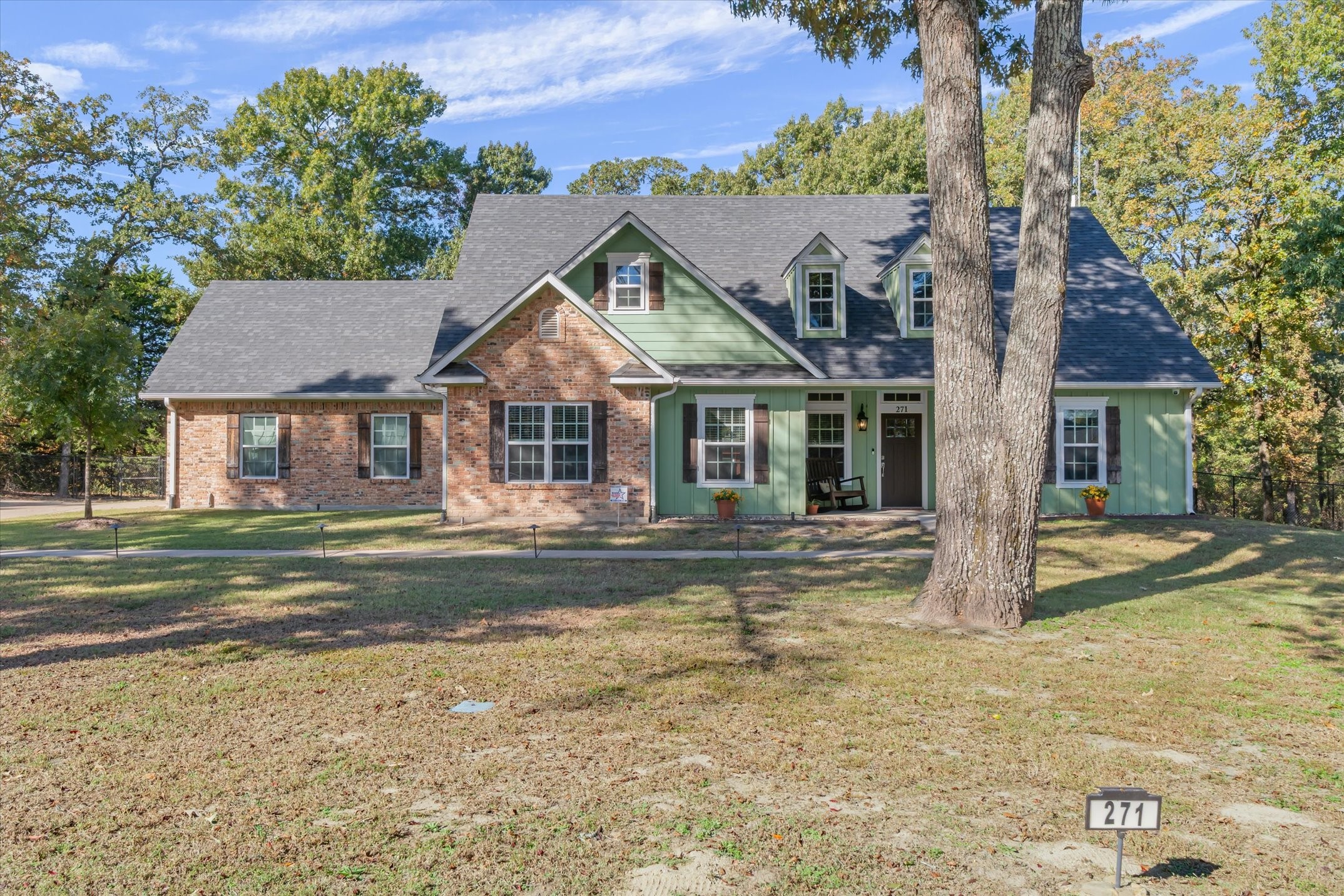 a front view of a house with a garden