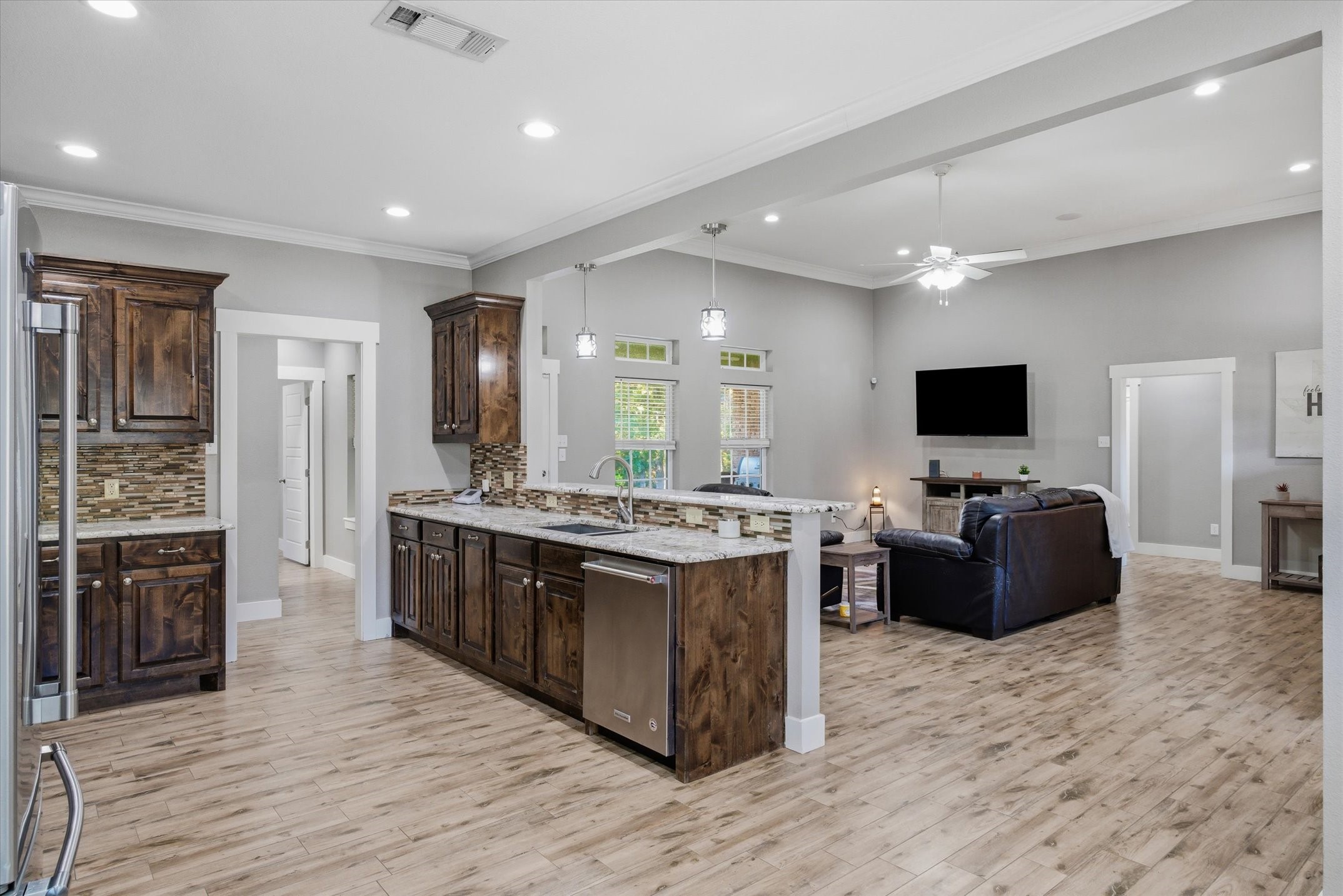 271 Rscr 4269 Emory, TX 75440 - Photo 22 of 48 a large kitchen with stainless steel appliances a stove top oven a sink dishwasher a dining table and chairs with wooden floor