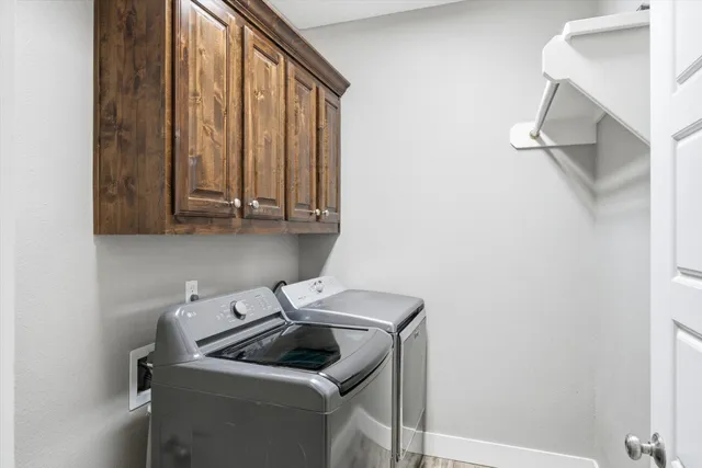 a living room filled with furniture and large windows