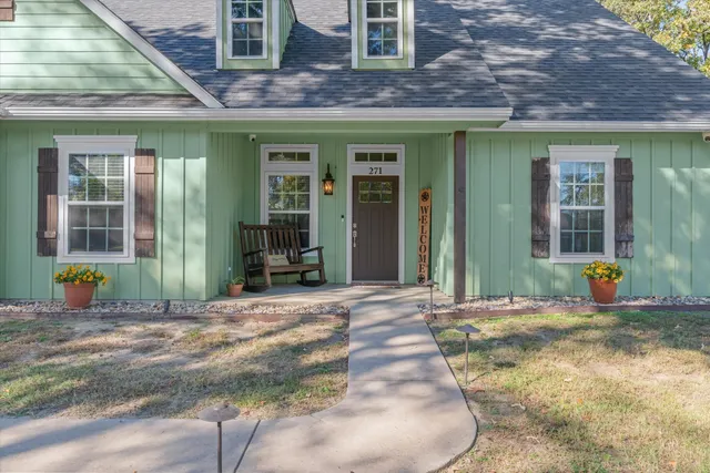 a view of a bedroom with furniture and windows
