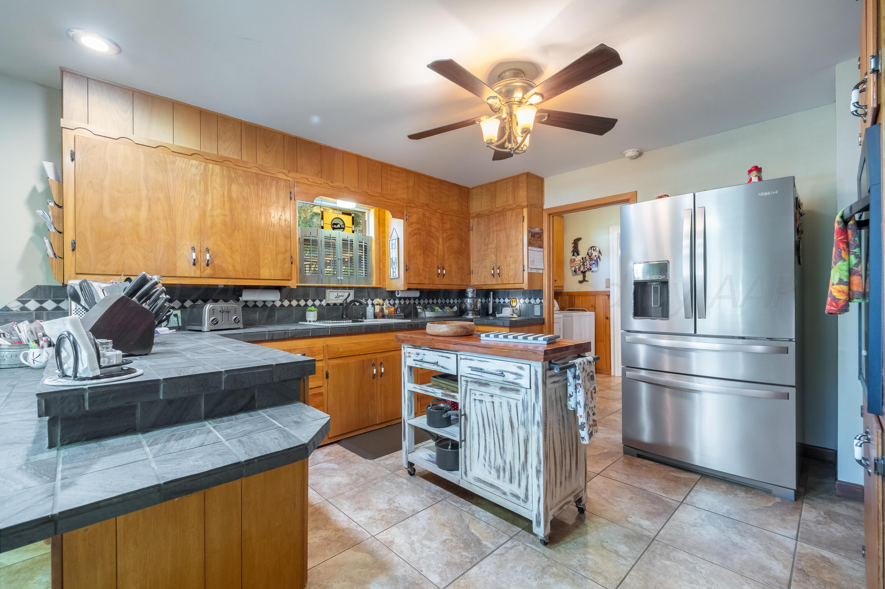 511 Cheyenne Street Wheeler, TX 79096 - Photo 12 of 45 a kitchen with stainless steel appliances granite countertop a sink stove and refrigerator