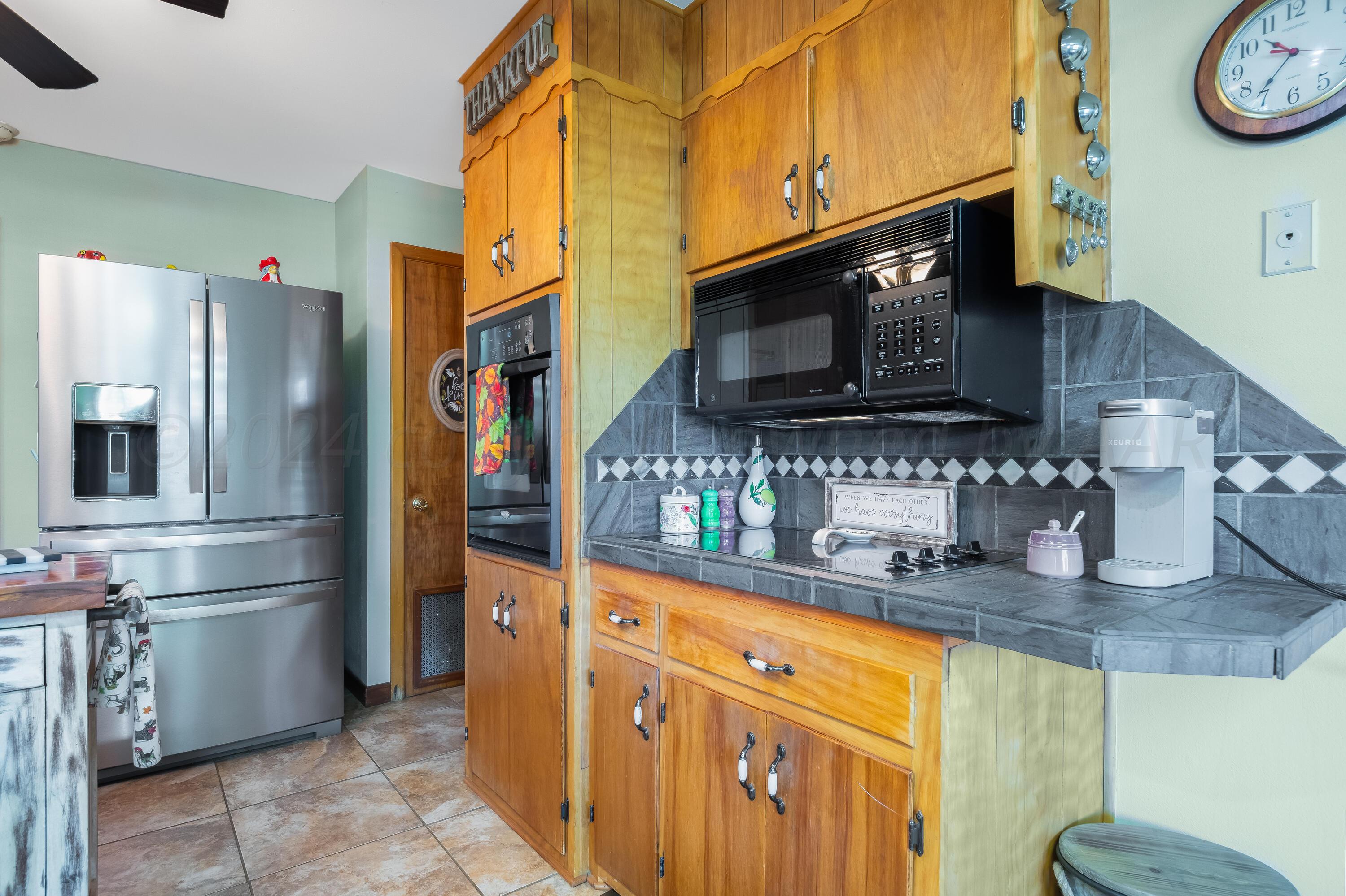 511 Cheyenne Street Wheeler, TX 79096 - Photo 13 of 45 a kitchen with stainless steel appliances granite countertop a refrigerator and a sink