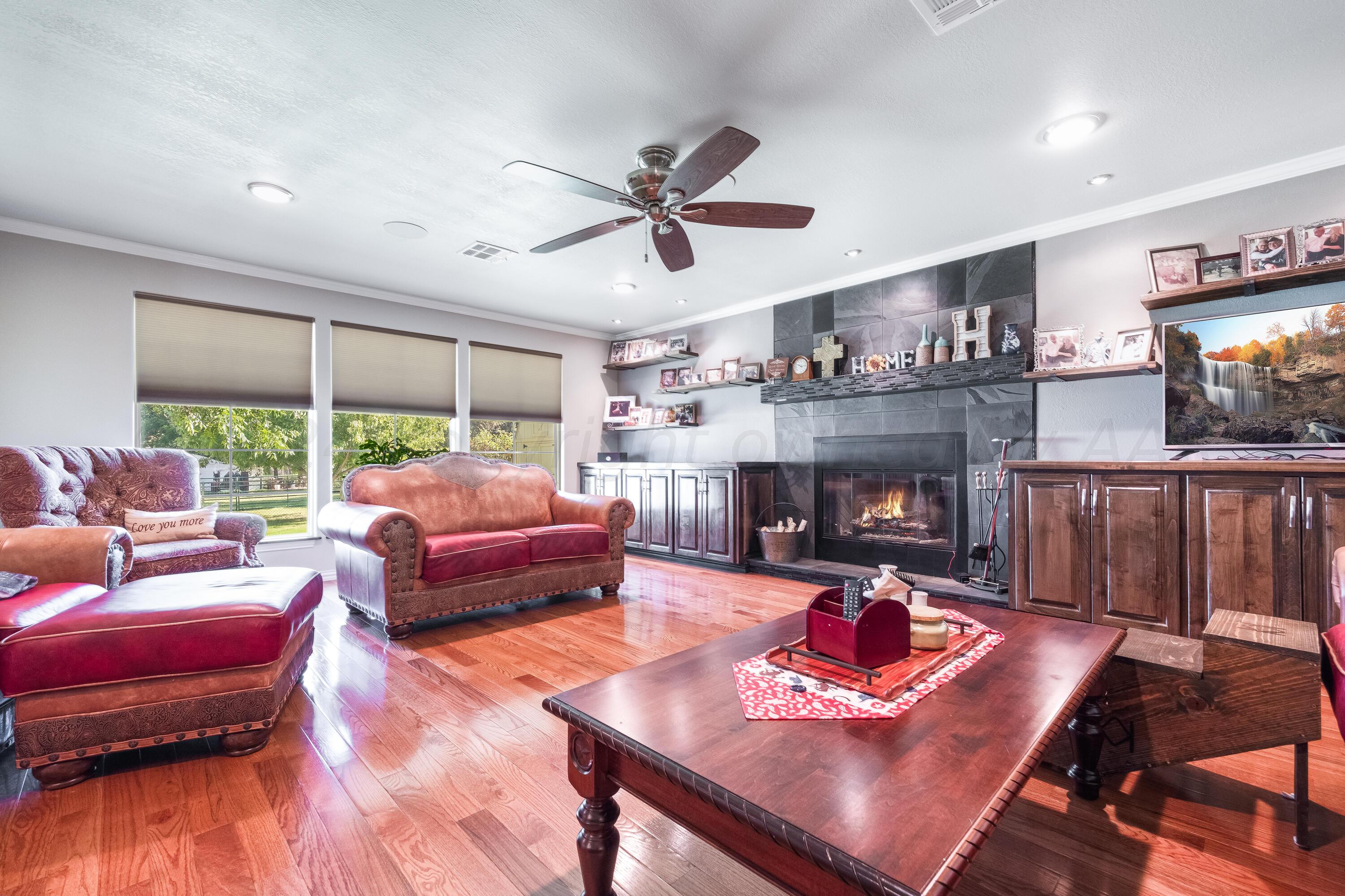 511 Cheyenne Street Wheeler, TX 79096 - Photo 19 of 45 a living room with furniture fireplace and a large window