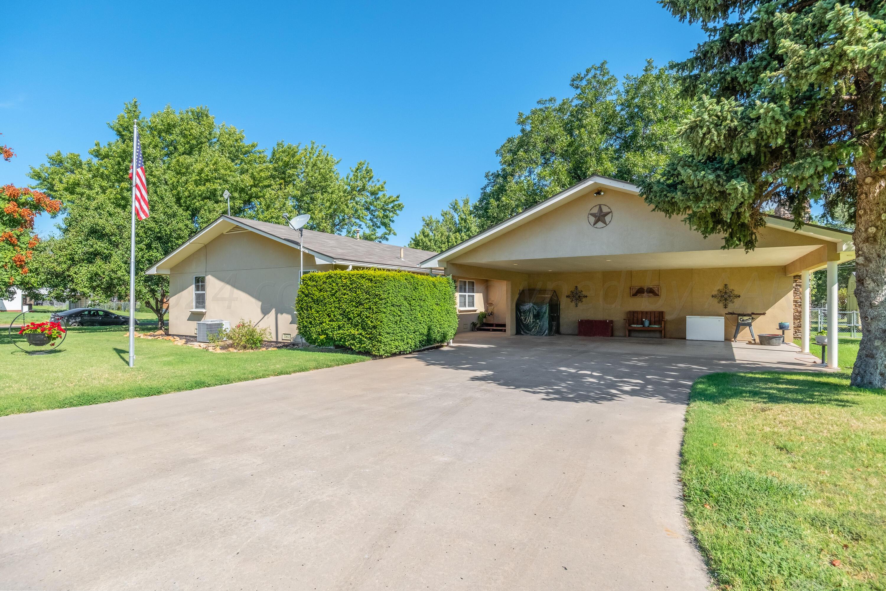511 Cheyenne Street Wheeler, TX 79096 - Photo 2 of 45 a front view of a house with a yard and garage