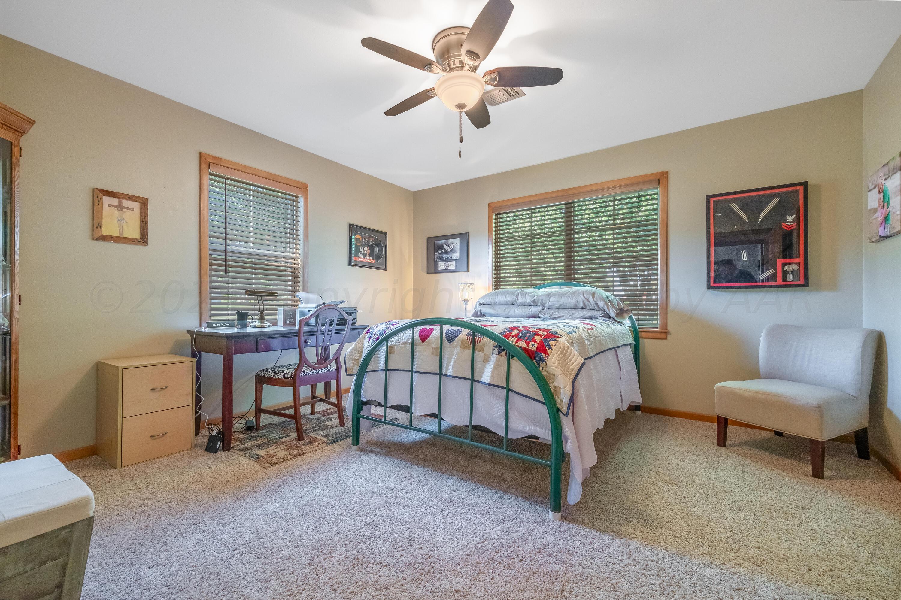 511 Cheyenne Street Wheeler, TX 79096 - Photo 30 of 45 a bedroom with a bed and a chandelier