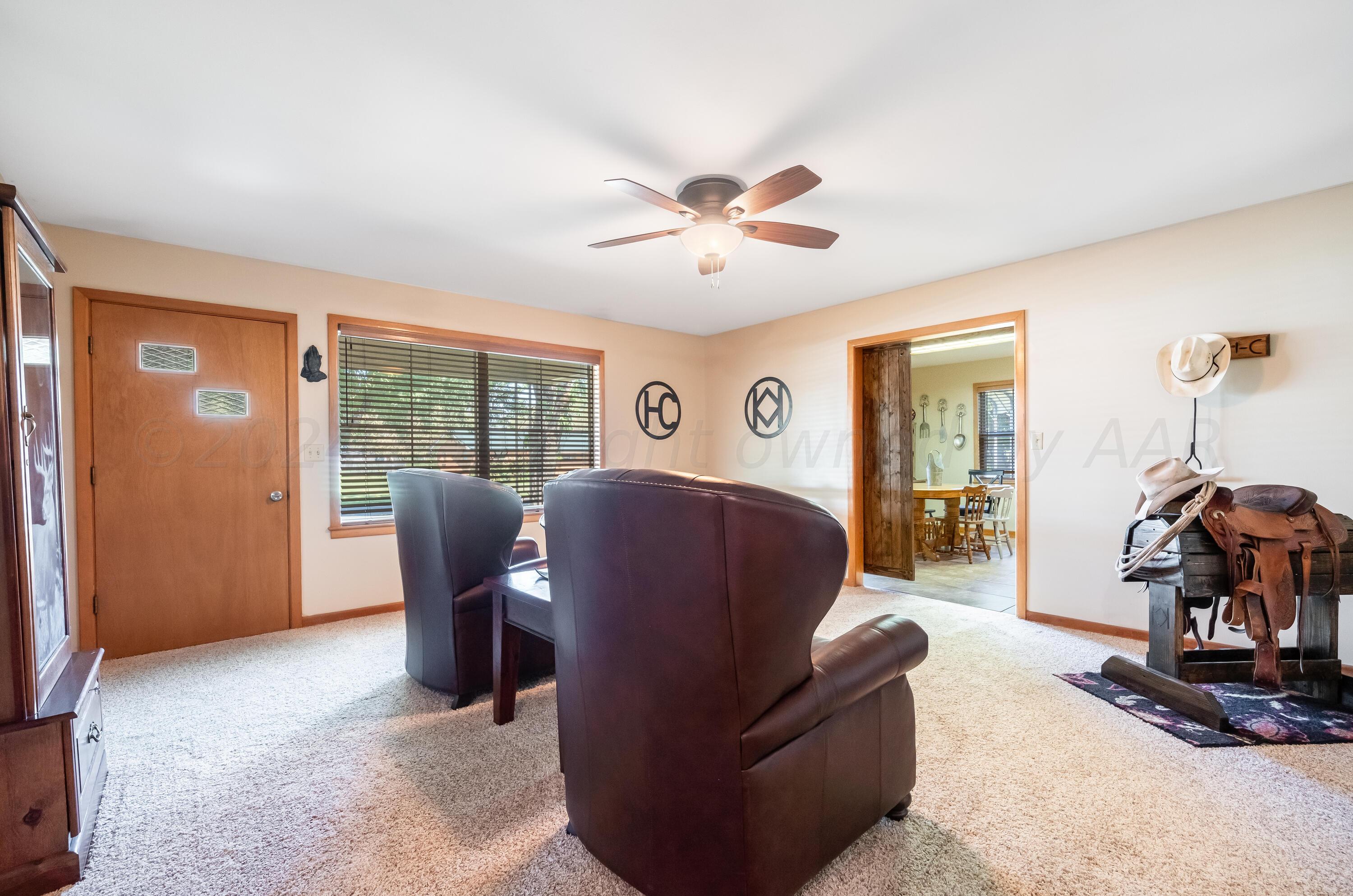 511 Cheyenne Street Wheeler, TX 79096 - Photo 3 of 45 a living room with furniture a ceiling fan and a window