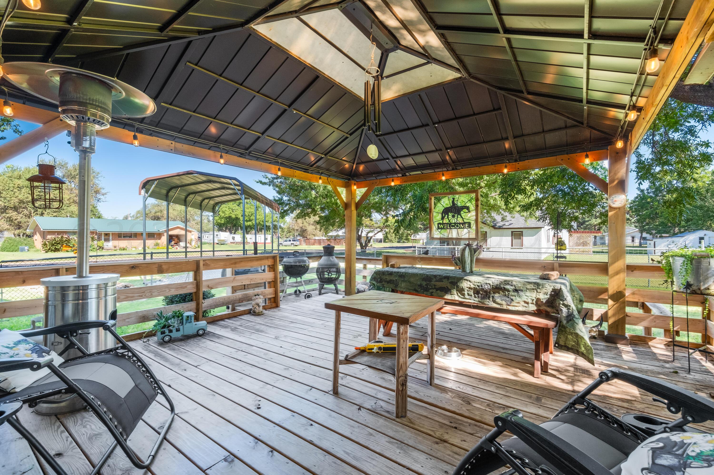 511 Cheyenne Street Wheeler, TX 79096 - Photo 34 of 45 a view of a patio with table and chairs potted plants with wooden floor