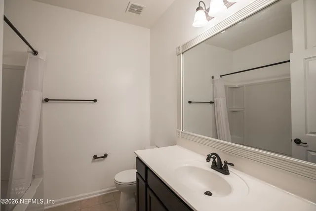 a bathroom with a sink a toilet a shower and a mirror