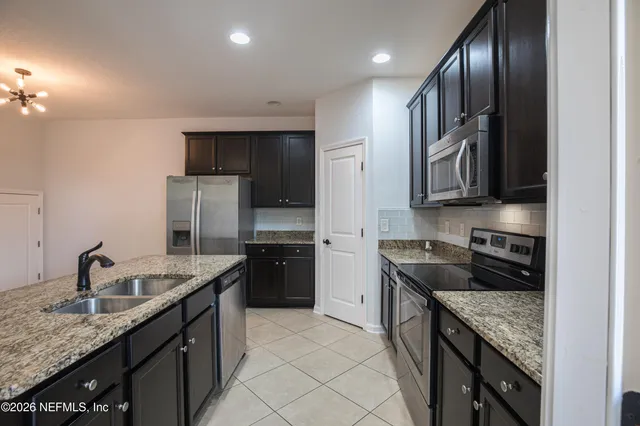 a kitchen with granite countertop stainless steel appliances and wooden cabinets