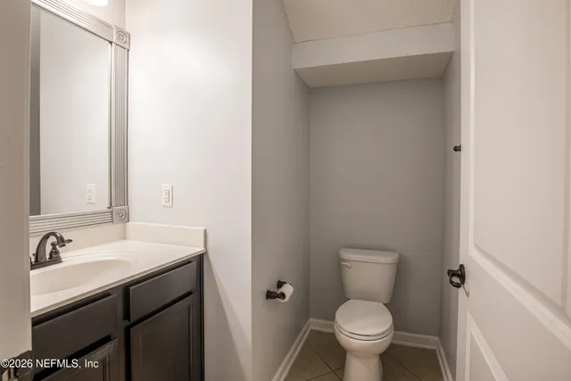 a bathroom with a sink toilet and a mirror