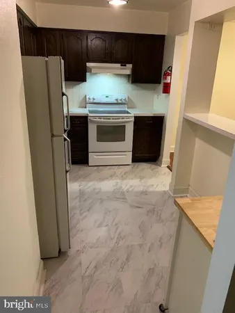 a kitchen with stainless steel appliances granite countertop a refrigerator and a stove