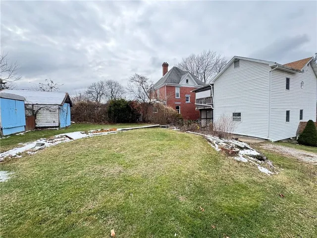 a view of a house with a yard and garage