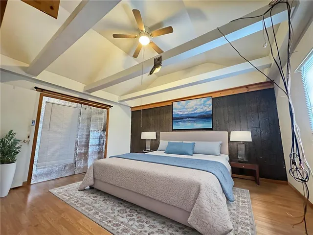 a bedroom with a large bed and a window