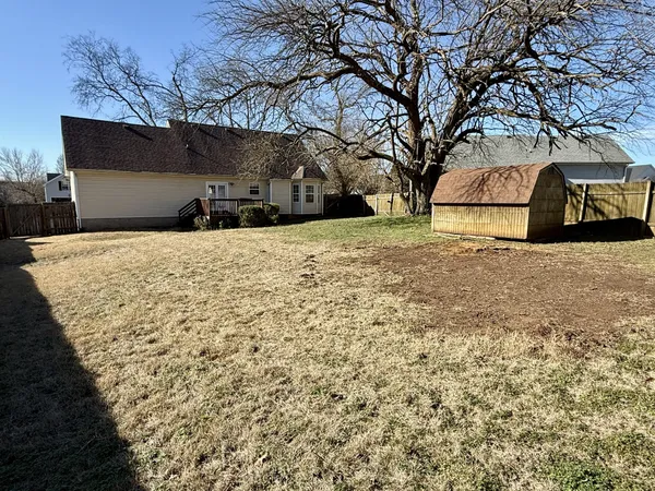 a yellow house with trees in front of it