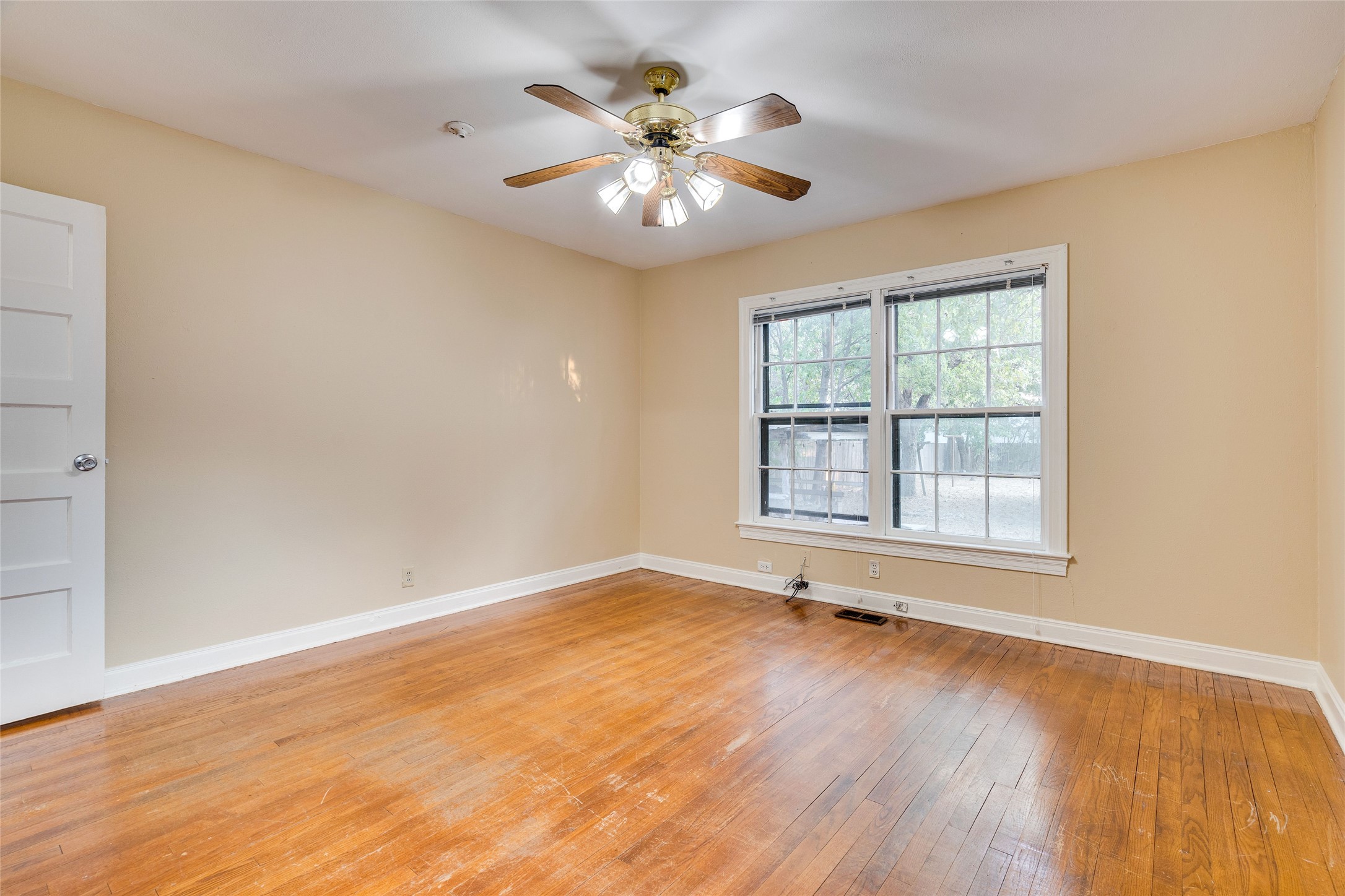 1011 East 49th Street Austin, TX 78751 - Photo 16 of 35 an empty room with wooden floor and windows