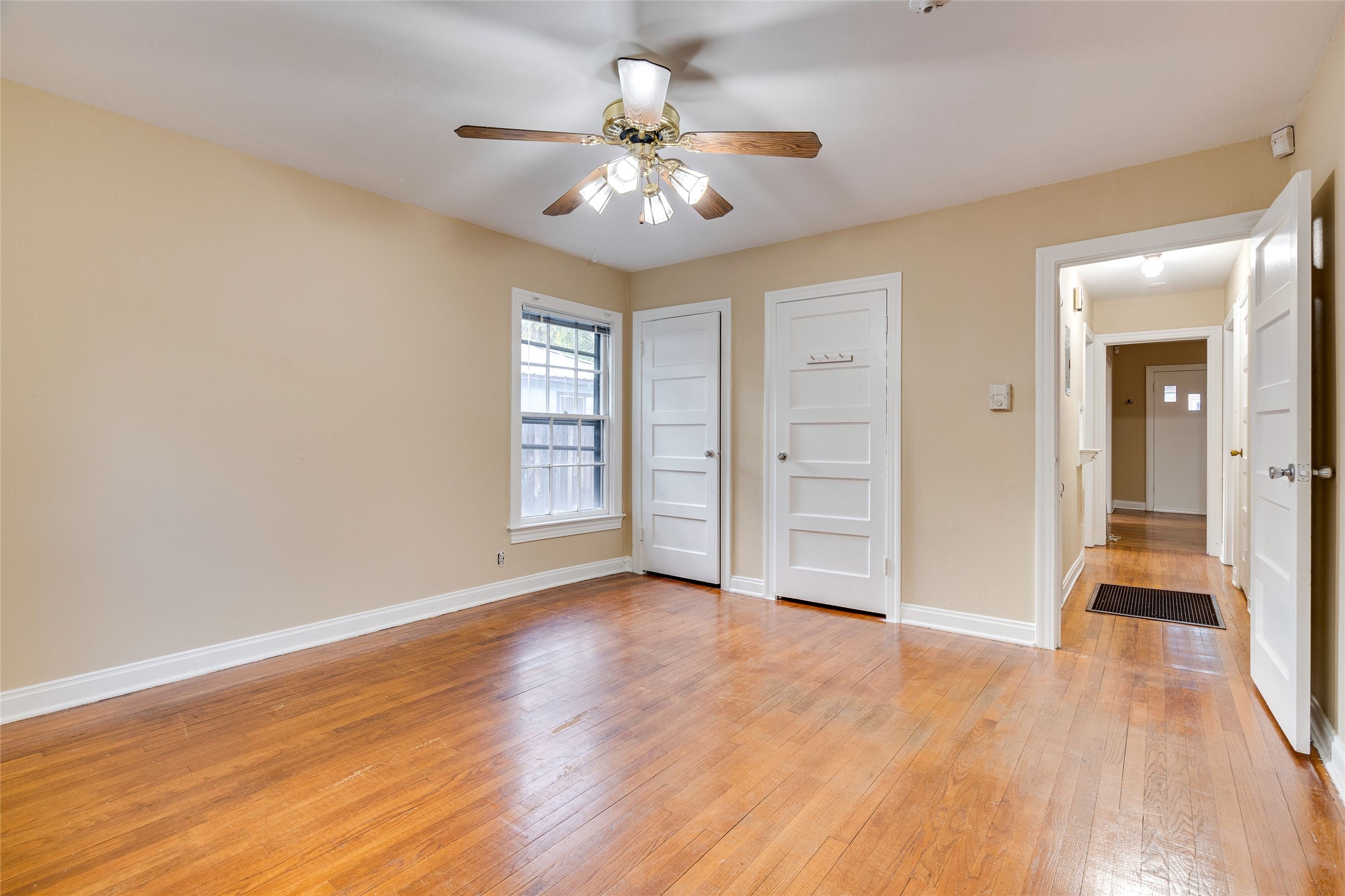 1011 East 49th Street Austin, TX 78751 - Photo 18 of 35 an empty room with wooden floor chandelier and windows