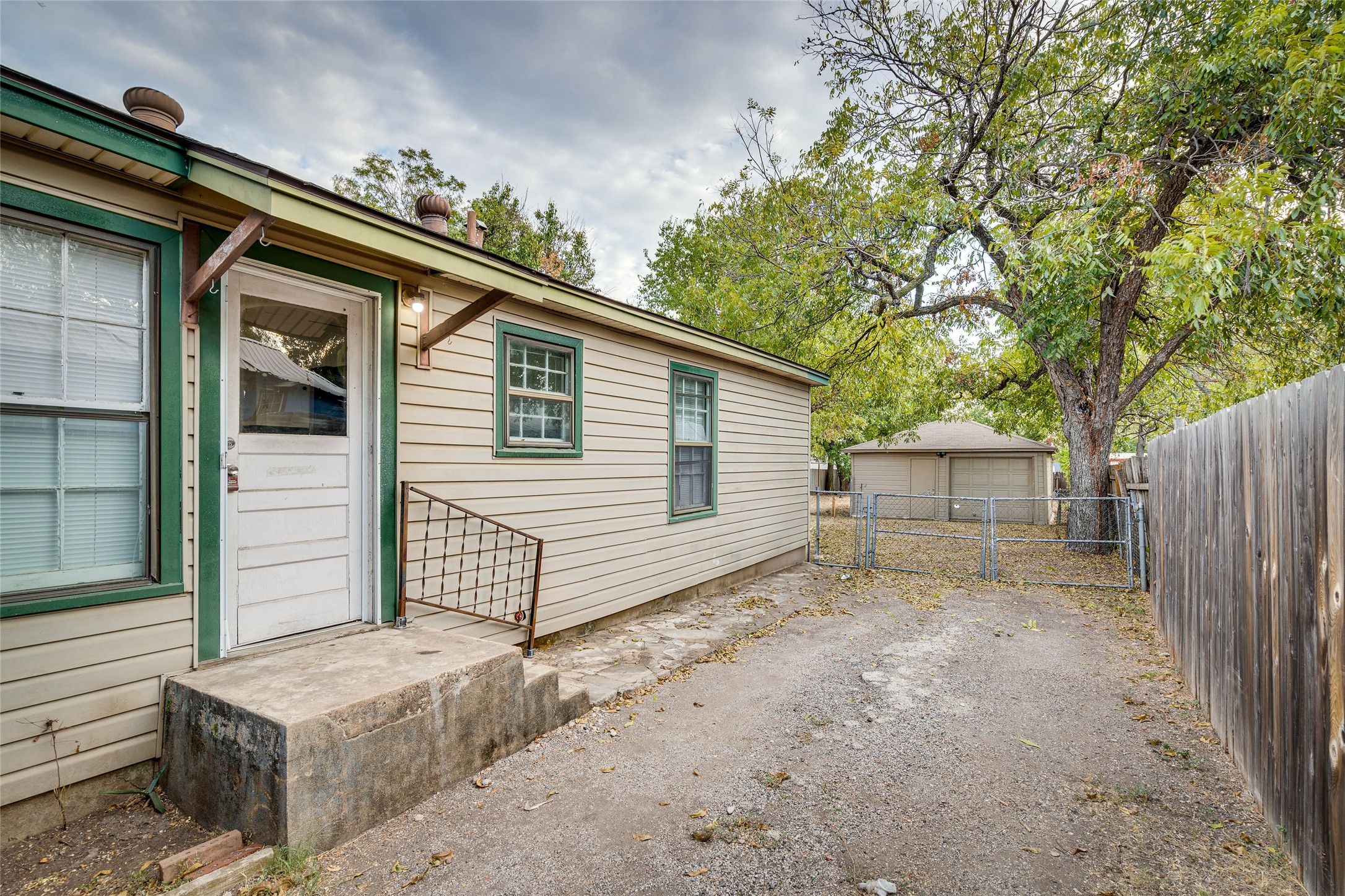 1011 East 49th Street Austin, TX 78751 - Photo 26 of 35 a view of a small house with a large window and wooden fence