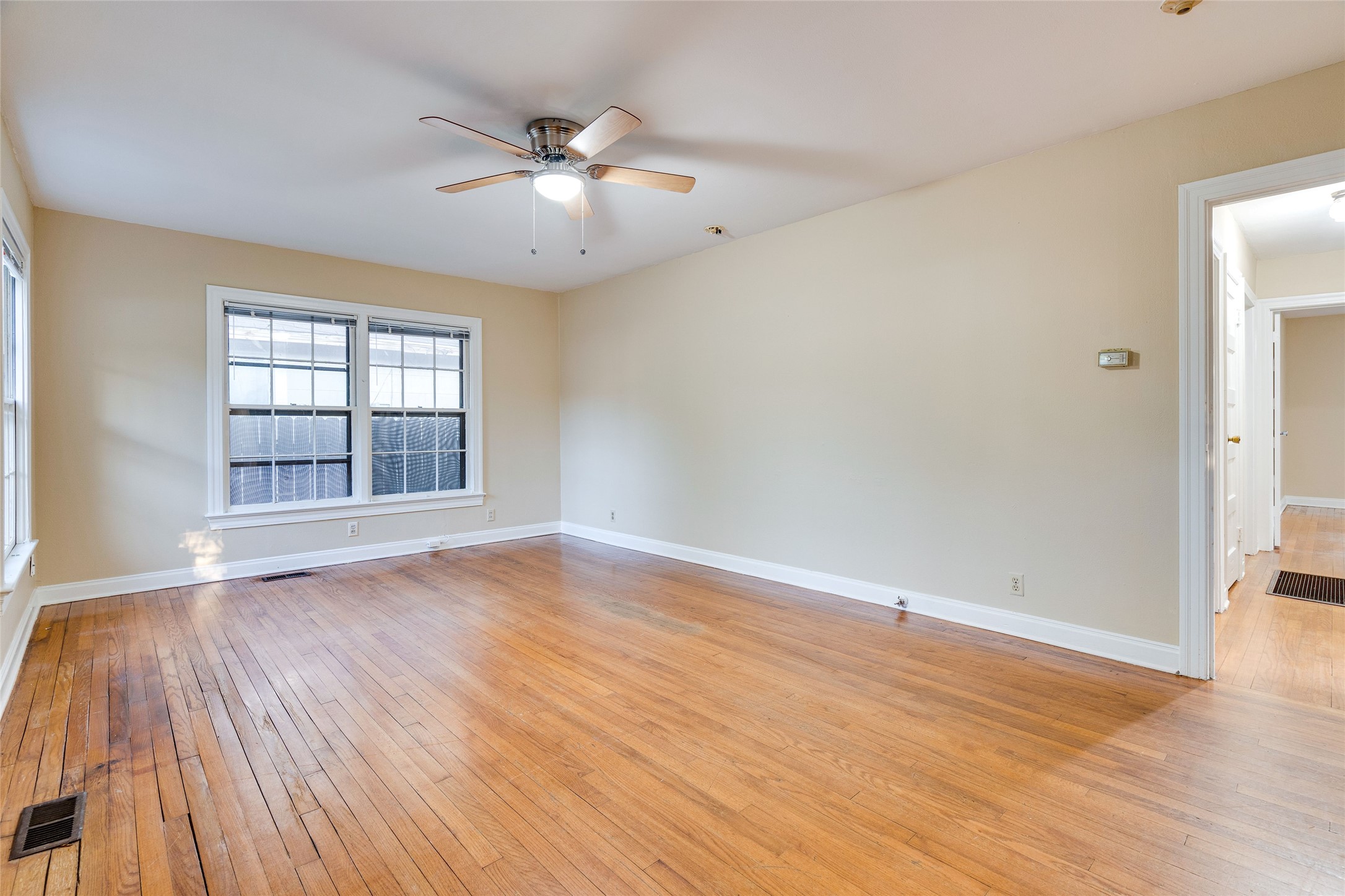 1011 East 49th Street Austin, TX 78751 - Photo 3 of 35 wooden floor in an empty room with a window