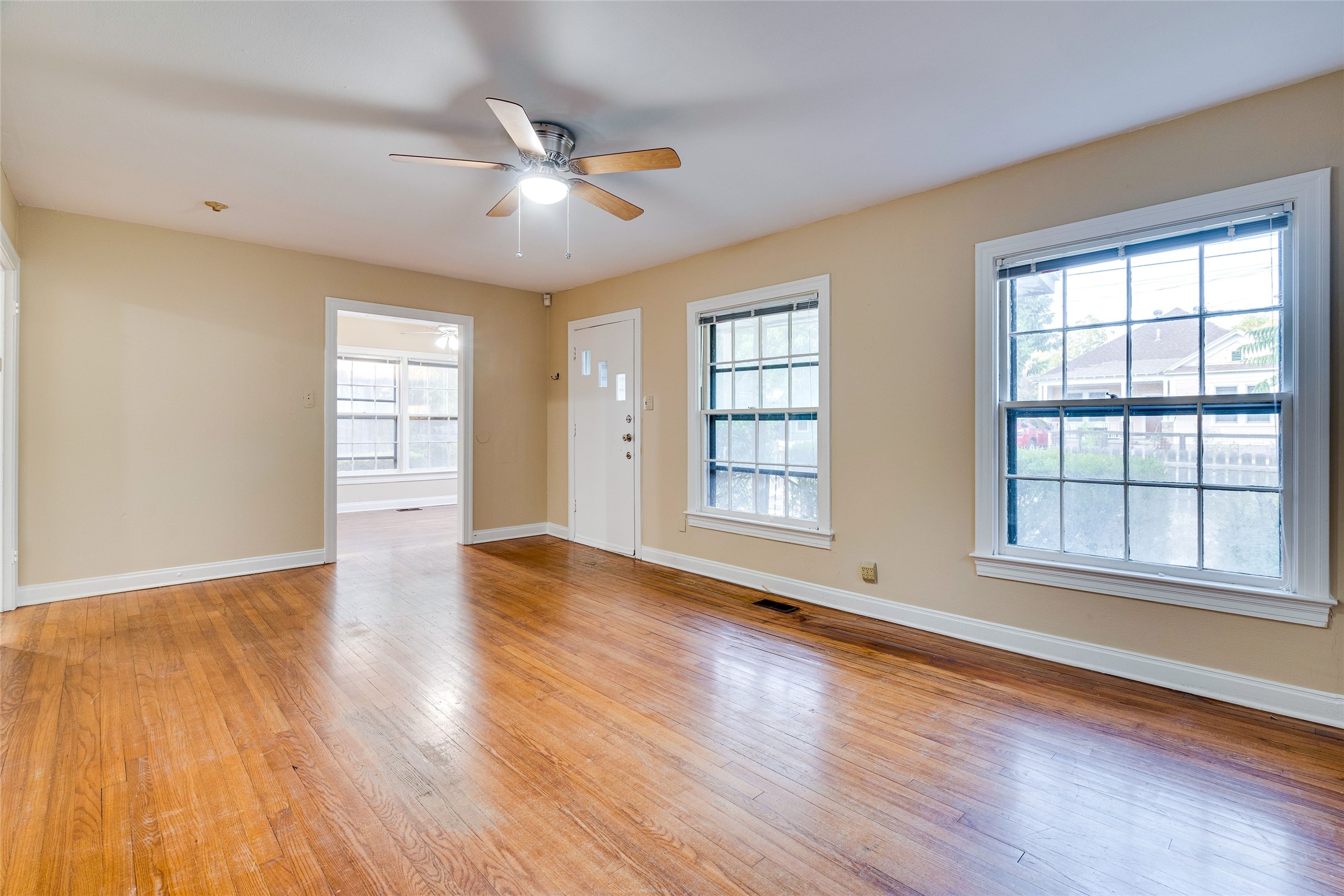 1011 East 49th Street Austin, TX 78751 - Photo 5 of 35 a view of an empty room with wooden floor and a window