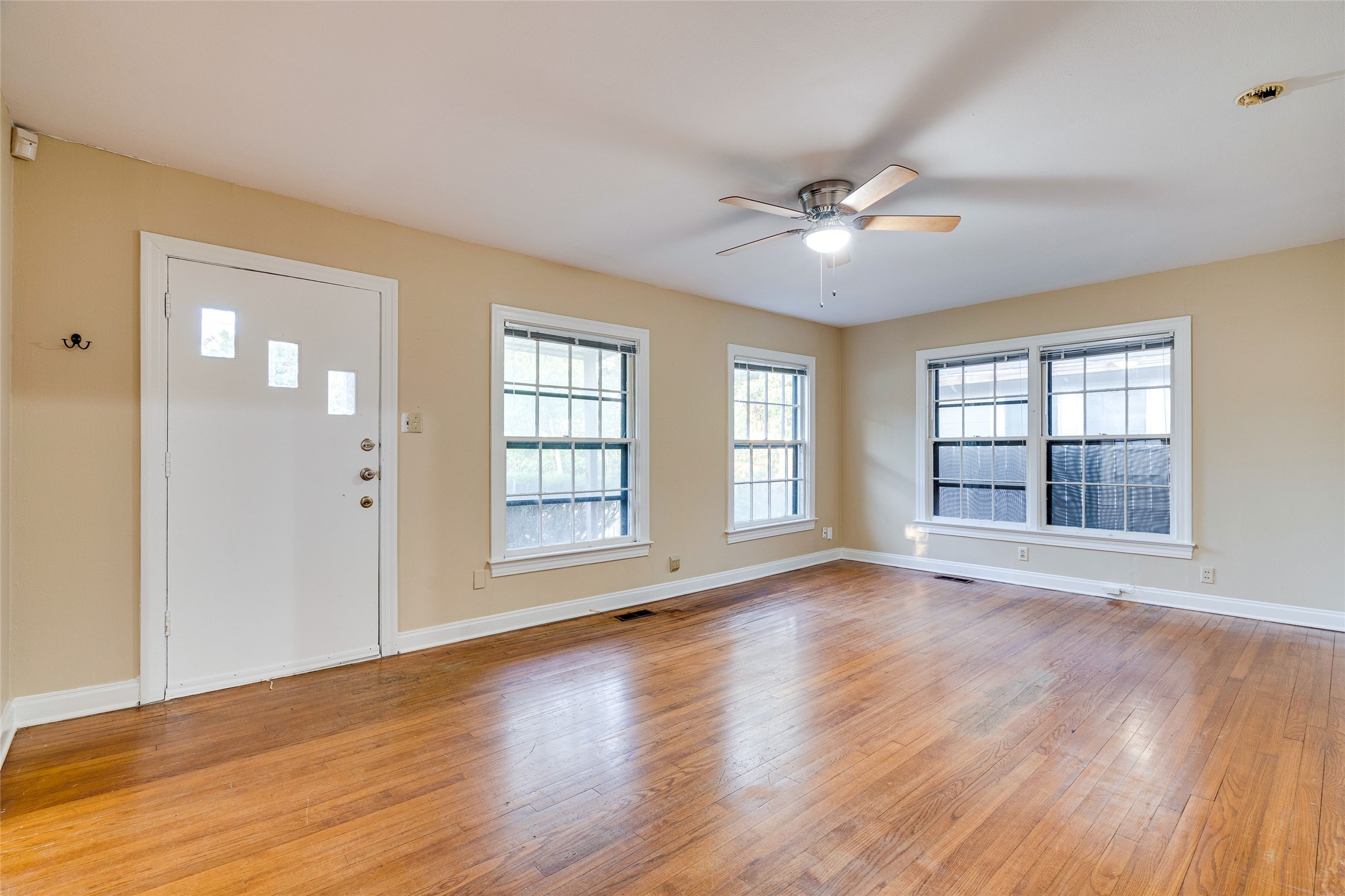 1011 East 49th Street Austin, TX 78751 - Photo 6 of 35 a view of an empty room with wooden floor and a window