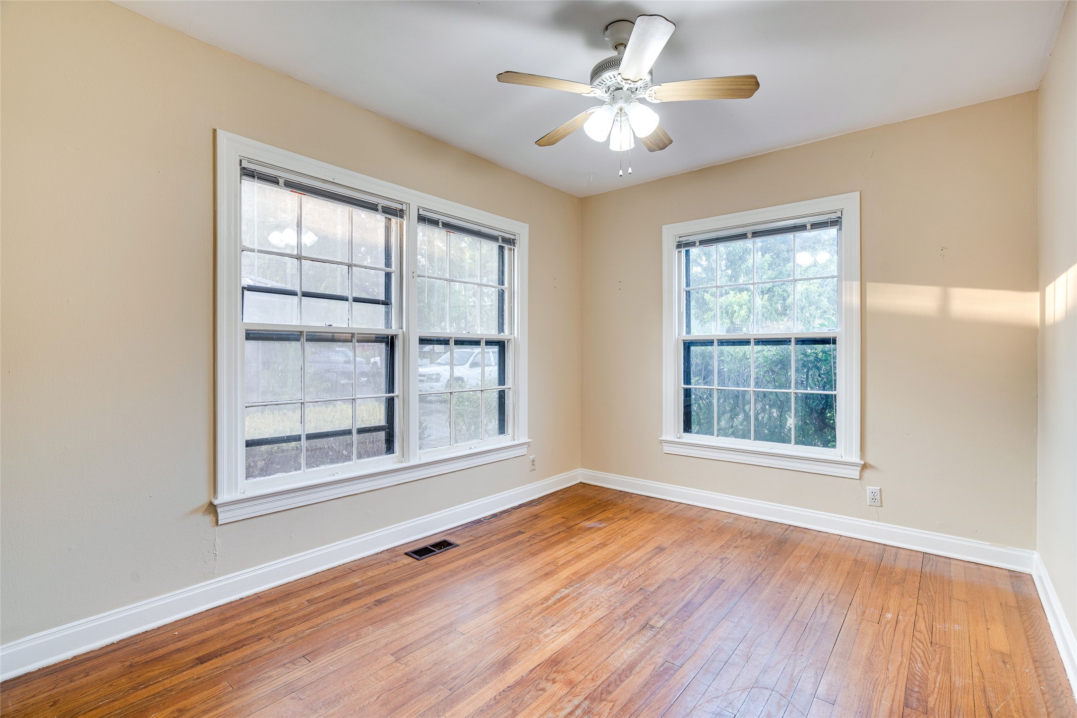 1011 East 49th Street Austin, TX 78751 - Photo 7 of 35 an empty room with wooden floor and windows