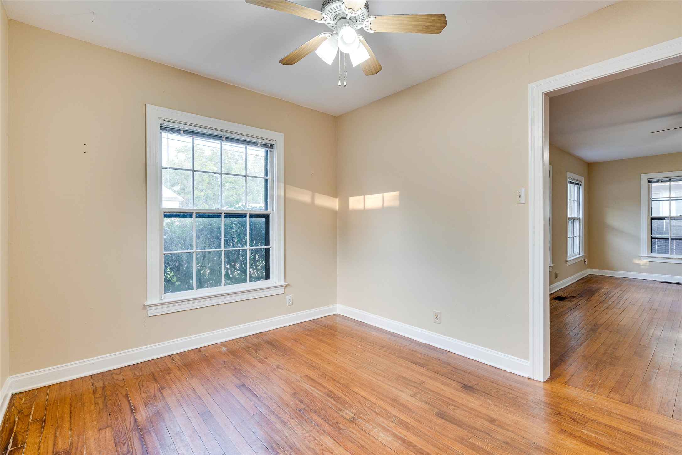 1011 East 49th Street Austin, TX 78751 - Photo 8 of 35 an empty room with wooden floor chandelier and windows
