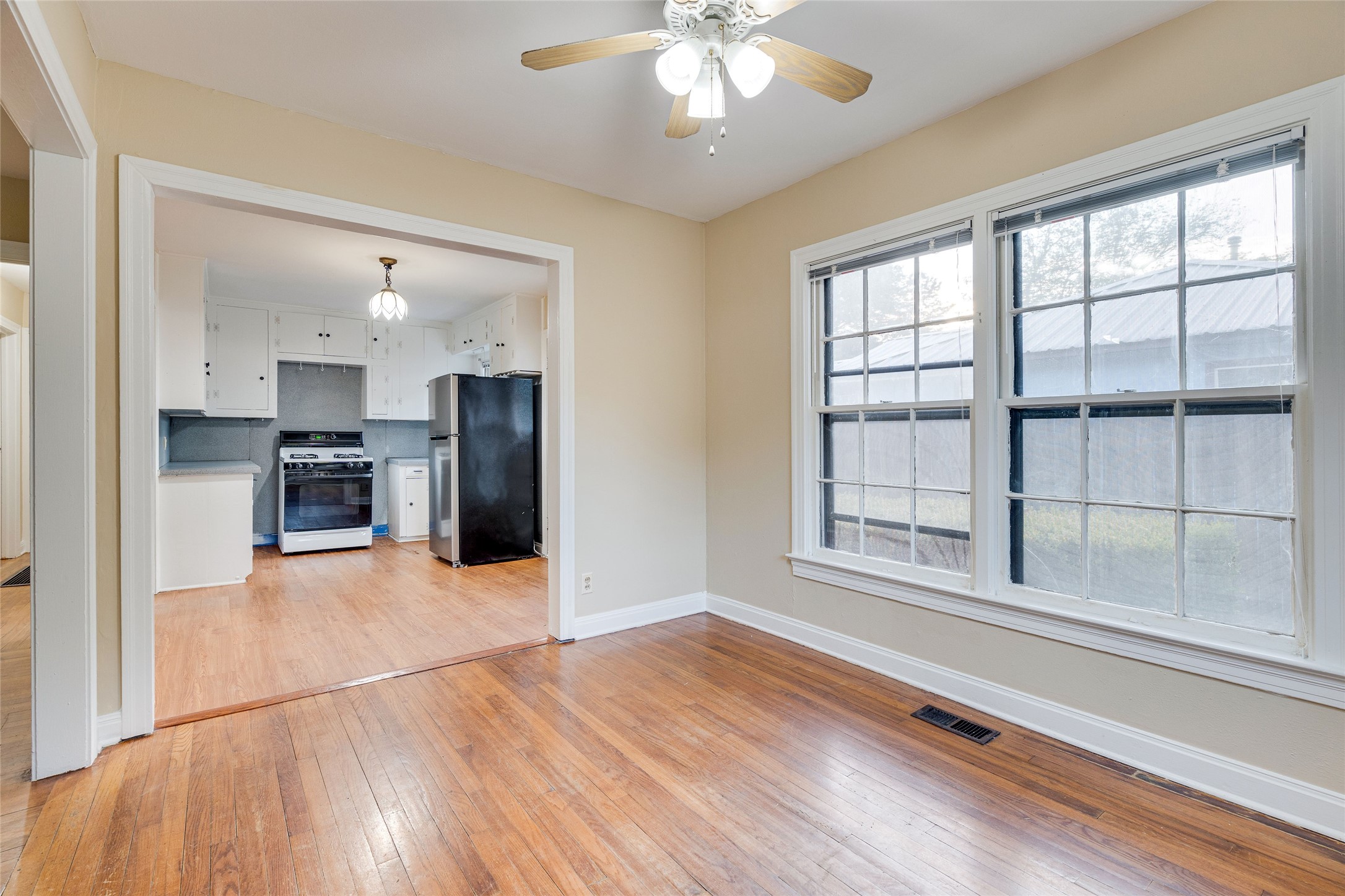 1011 East 49th Street Austin, TX 78751 - Photo 10 of 35 a view of an empty room with a window and wooden floor